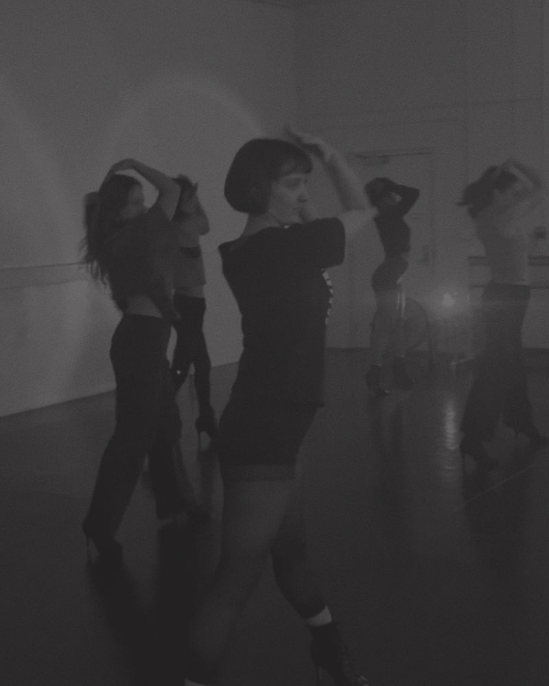 Dancers mid-routine in the studio