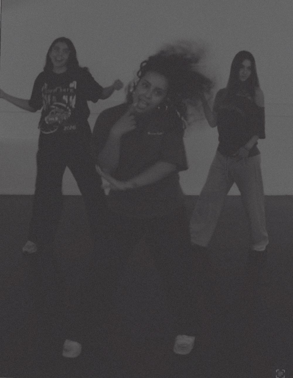 Three dancers laughing mid-routine